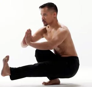 Dr. Mark Cheng holding a one-legged balance posture