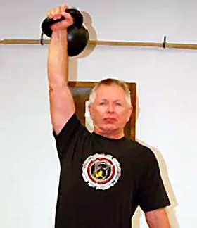 Gary Toppins pressing a kettlebell overhead